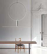 Flos Arrangements Pendant light hanging above a dining table in a spacious room.