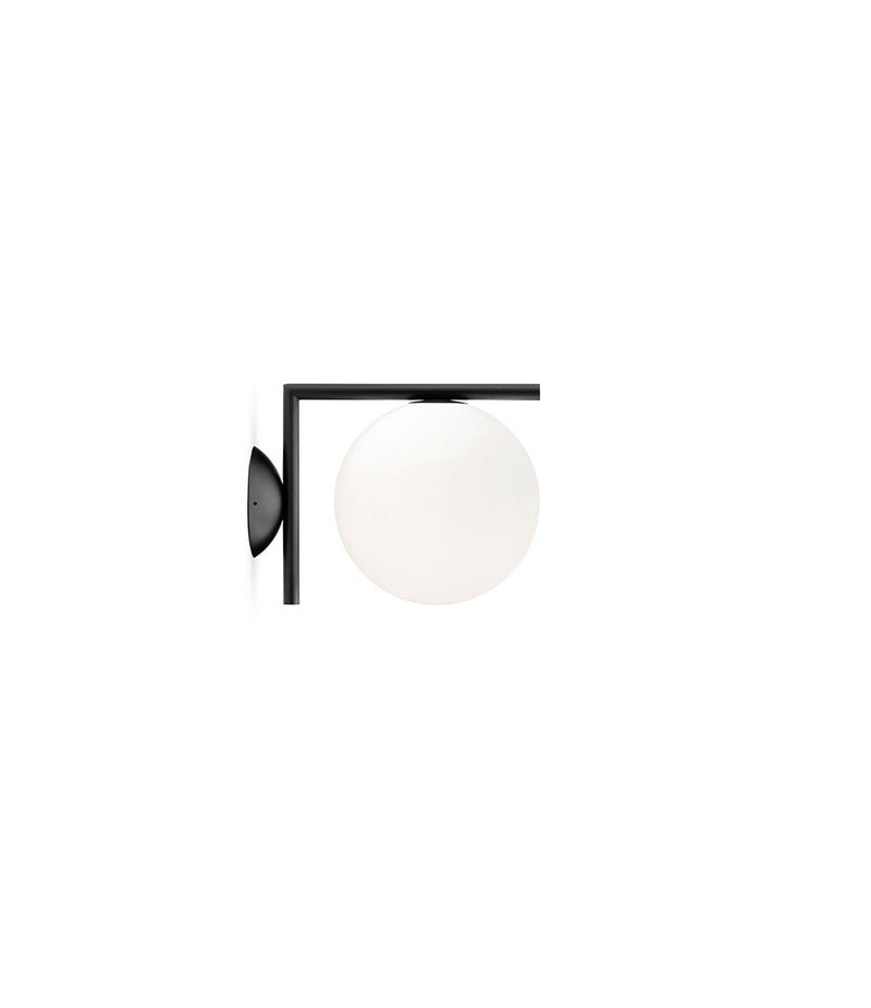 Small Flos IC Lights Ceiling/Wall sconce. Black L-shaped body connected to opaque white glass spherical diffuser.