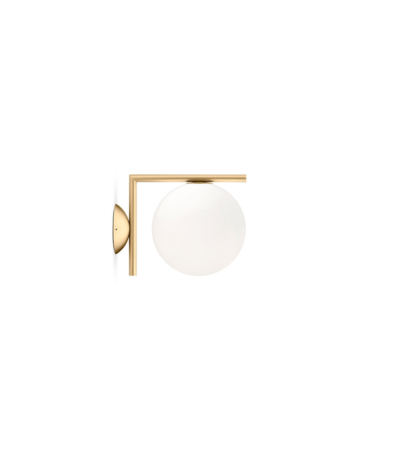 Small Flos IC Lights Ceiling/Wall sconce. Brass L-shaped body connected to opaque white glass spherical diffuser.