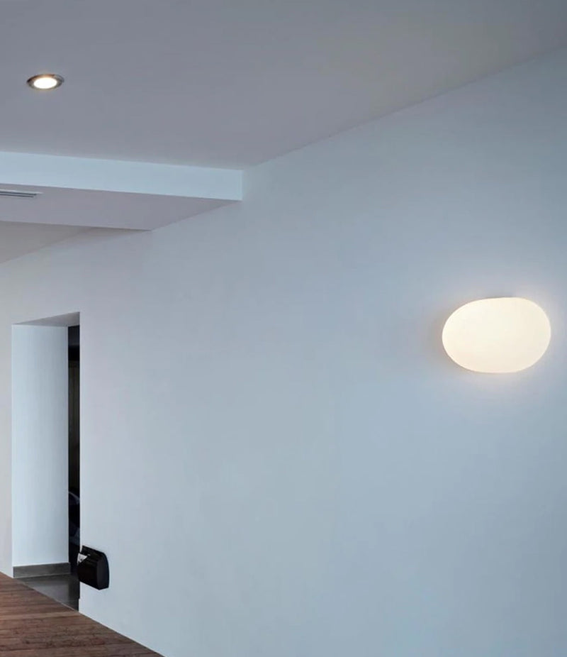 Flos Glo-Ball wall sconce on a wall in an apartment.