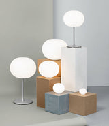 Group of Flos Glo-Ball lamps on display at the centre of a room.