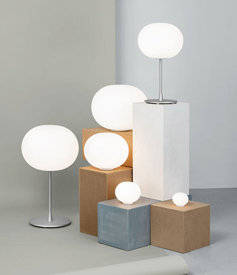 Group of Flos Glo-Ball lamps on display at the centre of a room.