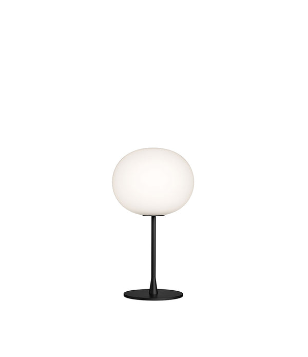 Flos Glo-Ball table lamp, with opaque white glass spherical diffuser atop a matte black stem and base.