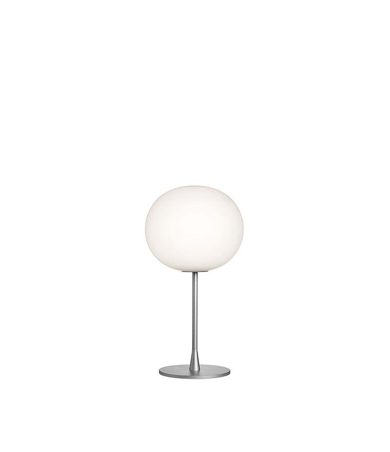 Flos Glo-Ball table lamp, with opaque white glass spherical diffuser atop a silver stem and base.