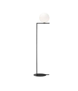 Flos IC Lights Floor Lamp, with opaque white glass spherical diffuser mounted atop an L-shaped black stem.