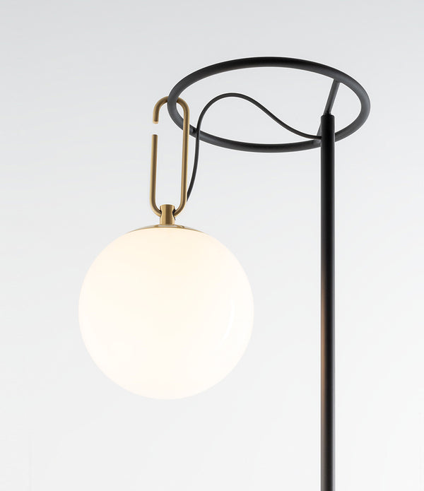 Artemide NH floor lamp globe diffuser hangs from circular ring of lamp stem via an oval-shaped hook.