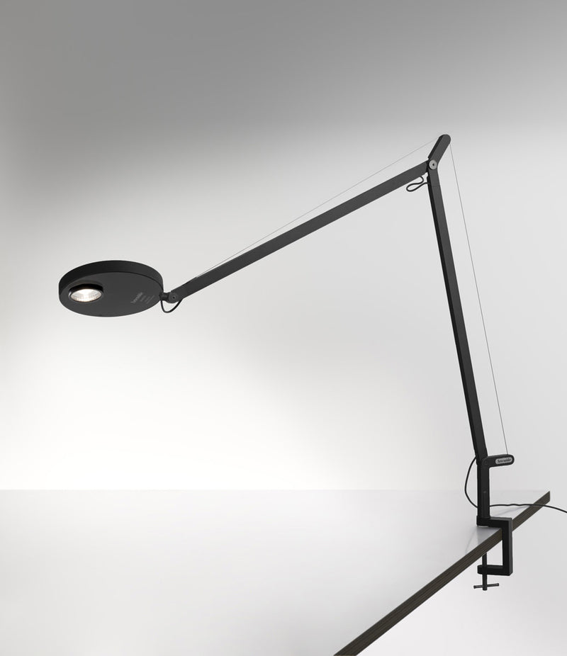 Artemide Demetra Professional table lamp with clamp, mounted to a desk.