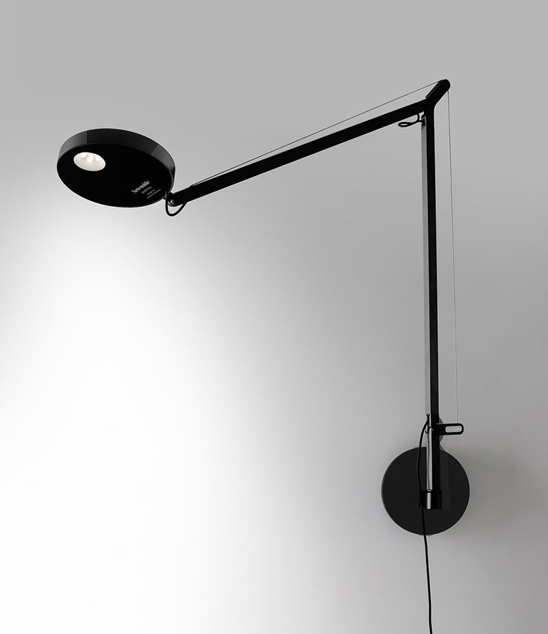 Artemide Demetra wall lamp in black, mounted to a wall.