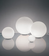 Artemide Dioscuri 14, 25, 35 and 42 grouped together on a glass surface.