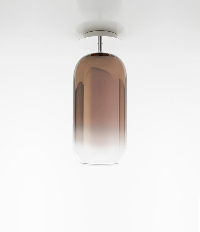 Pill-shaped Artemide Gople ceiling lamp, with blown glass diffuser in gradient bronze.