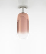Pill-shaped Artemide Gople ceiling lamp, with blown glass diffuser in gradient copper.