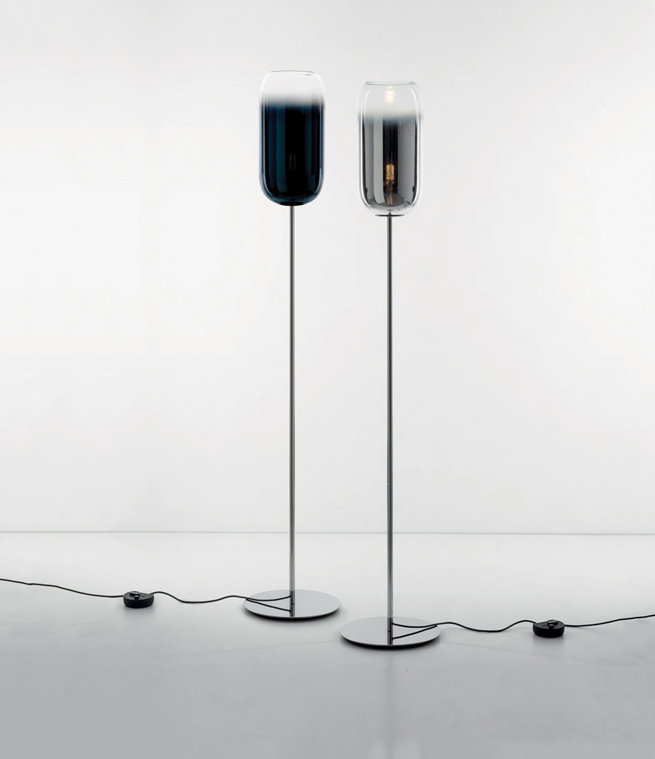A blue and a silver Artemide Gople floor lamp side by side.