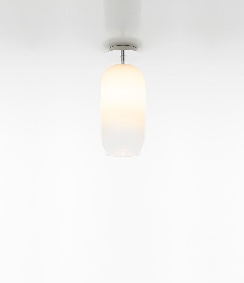 Artemide Gople Mini ceiling lamp, with pill-shaped blown glass shade in gradient white.