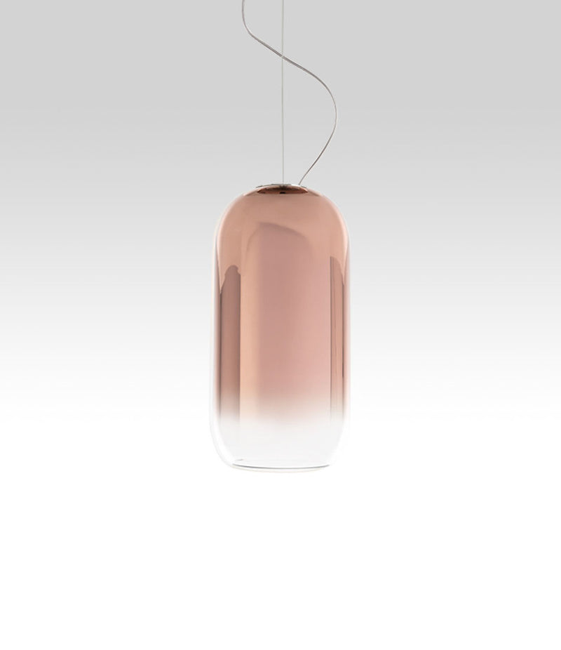 Pill-shaped Artemide Gople suspension lamp, with blown glass shade in gradient copper.