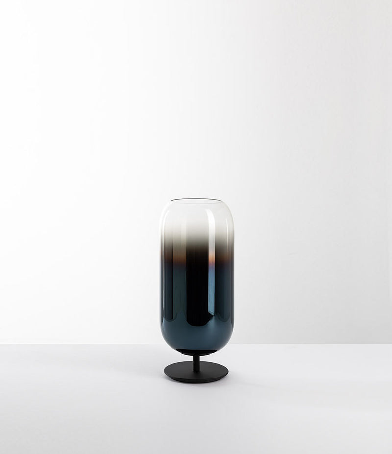 Artemide Gople Mini table lamp, with black steel base and blown glass pill-shaped shade in gradient blue.