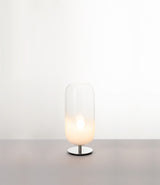 Artemide Gople Mini table lamp, with chrome steel base and blown glass pill-shaped shade in gradient white.