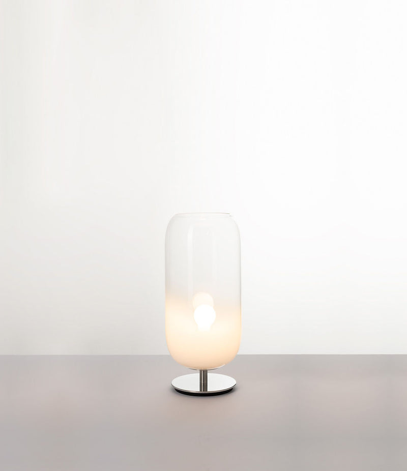 Artemide Gople Mini table lamp, with chrome steel base and blown glass pill-shaped shade in gradient white.