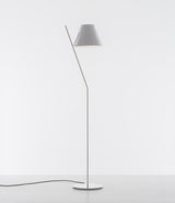 White Artemide la Petite floor lamp with tilted stem and conical shade. 