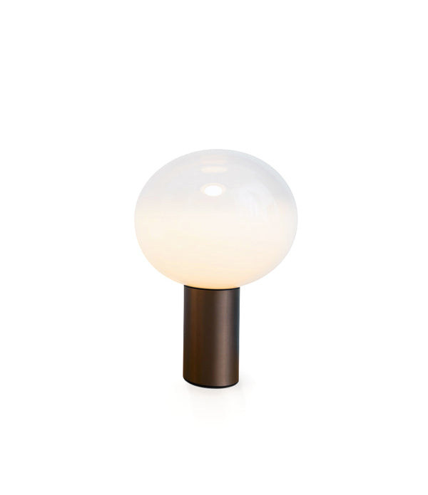 Artemide Laguna table lamp, with spherical white blown glass diffuser atop a cylindrical satin bronze base.