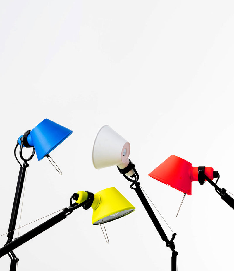 Blue, yellow, white and red Artemide Tolomeo Bi-color table lamps in various positions.