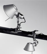 Two Artemide Tolomeo Clip Spot lights clamped to a bar, one above and the other below.