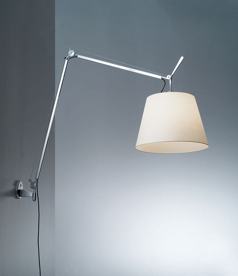 Parchment shaded Artemide Tolomeo Mega wall lamp mounted to a wall.