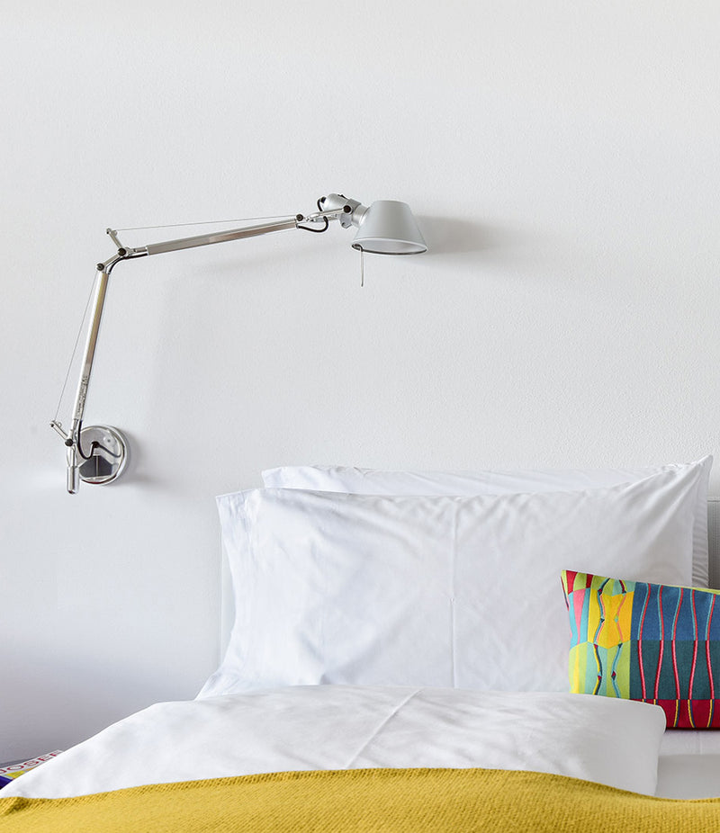 Artemide Tolomeo wall lamp mounted above a bed to a J-bracket.