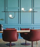 Artemide Yanzi SC1 suspension lamp mounted above dining table and dining chairs.