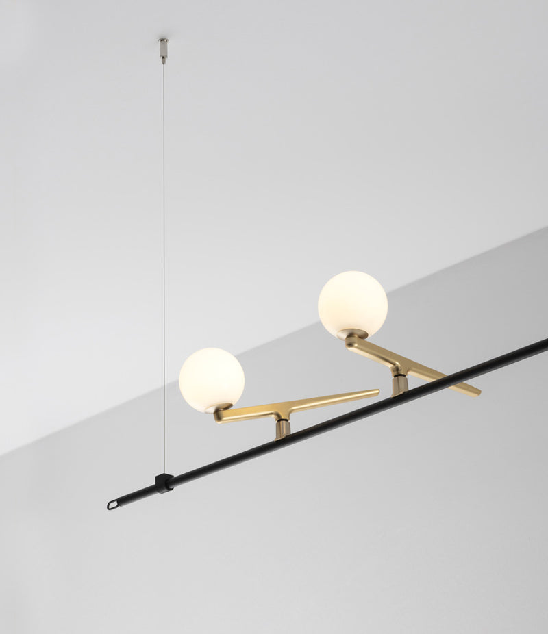 Two bird-like lights perched on horizontal bar of Artemide Yanzi SC1 suspension lamp.