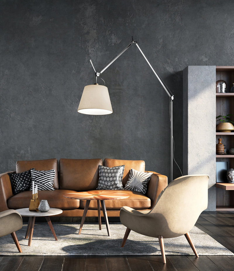 Artemide Tolomeo Mega floor lamp above a leather sofa and coffee table set.