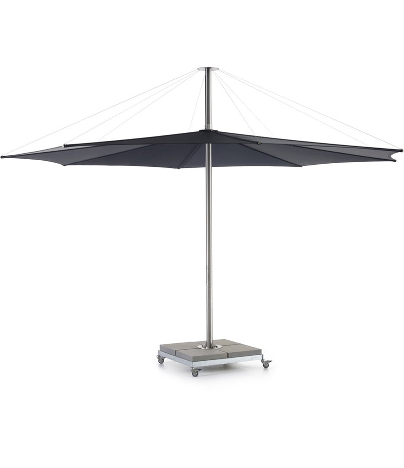 Black Extremis Inumbra umbrella, with weighted square base on wheels.