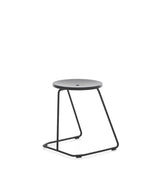 Extremis Tiki Stackable low stool, with black circular seat atop black wire frame.