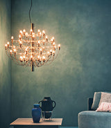 Flos 2097/30 suspension lamp hangs over small coffee table containing ornamental vases.