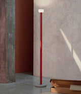 Flos Bellhop Floor lamp, with brick red stem, grey base and white inverted diffuser.