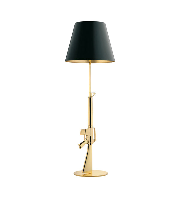 Flos Guns Floor Lamp, with gold stem in the shape of an assault rifle, and black lampshade.