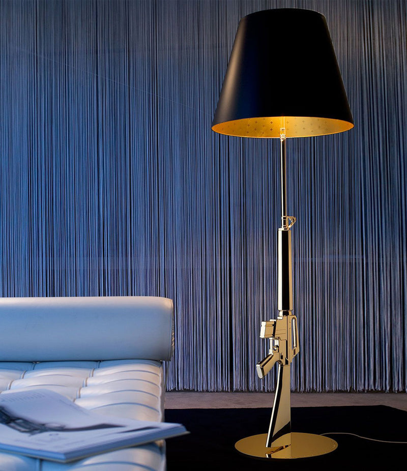 Flos Guns Floor Lamp next to a leather daybed.