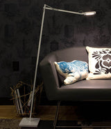 White Flos Kelvin Edge LED floor lamp beside a leather sofa.