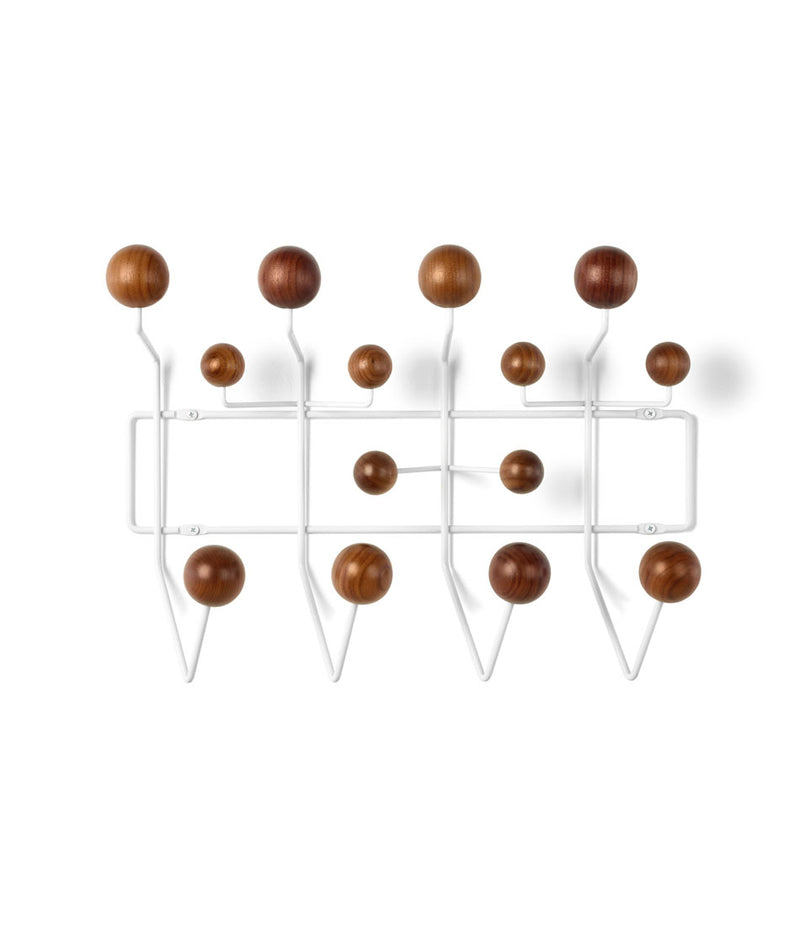 Wall mounted Herman Miller clothing hangar system with white frame and walnut ball hooks.