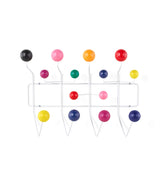 Wall mounted Herman Miller clothing hangar system with white frame and multi-coloured ball hooks.