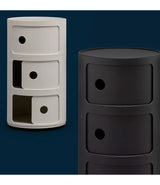 Two three level Componibili circular storage towers side by side, one white, one black.