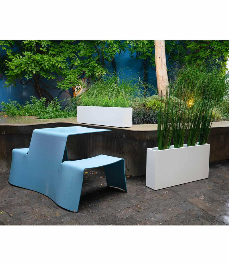 Layer All Day and Everyday aluminum planters next to picnic table in a courtyard.