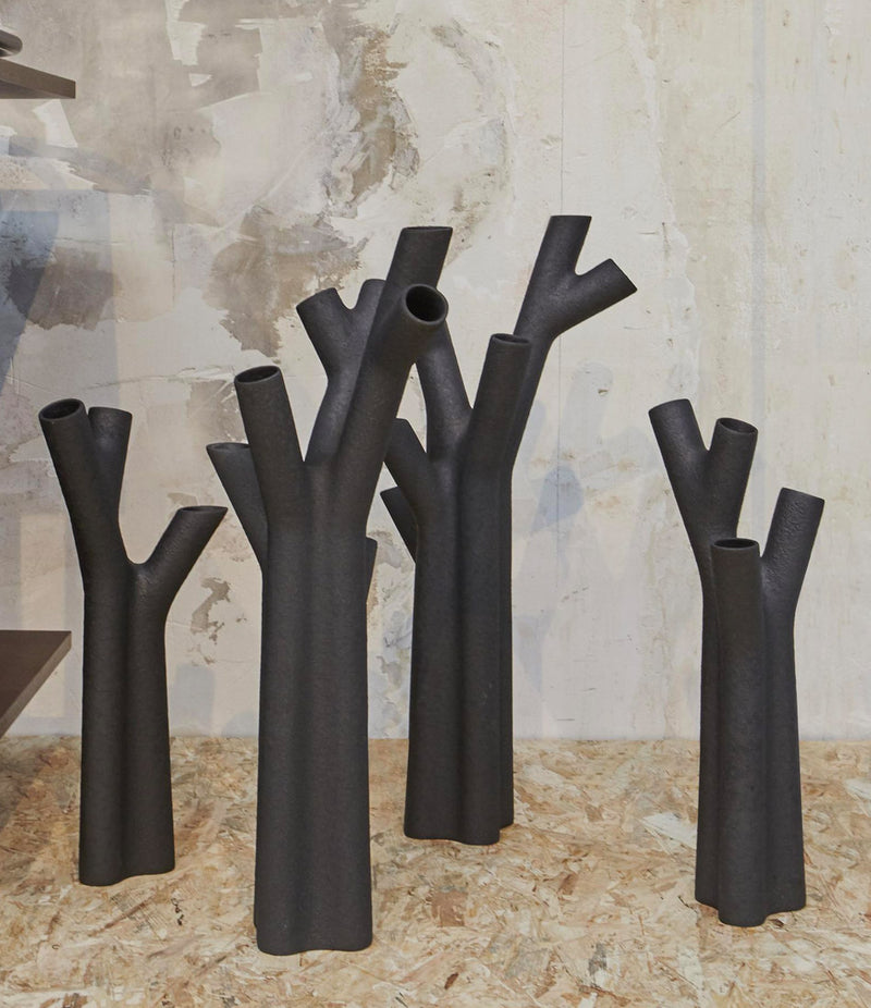 Group of four Ligne Roset Roseau vases on a wood surface.